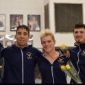 Shihab with members of the swim team holding flowers