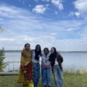 Student posing in front of lake with friends from different countries jpeg