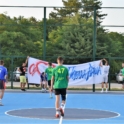 YES alum on a track field with a green jersey.