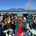 Tazrian Kabir Arwa hold Bangladeshi flag while taking a photo with students from her history class