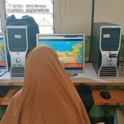 The Backs Of Three Children Doing English Activities On Computers