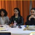 Three Pensive Looking Young Women Sitting At A Table