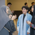 Three young women speaking in a circle