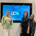 Three young women standing in front of the LCOY logo