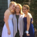 YES student, Vesa, in a prom dress standing next to her host mom and host sister