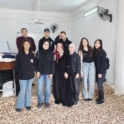 Group of alumni standing in a group and smiling