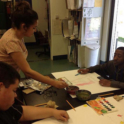 Yes Alumna Guiding Two Students Through A Painting Assignment