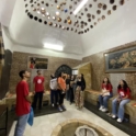 YES alumni around a fountain looking up at a rock art installation