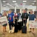 Yaqoub his DP and host parents with welcome signs