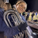 Zeineb holding her euphonium in the bleachers