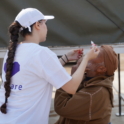 Imane applying eye drops to a patient