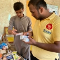 YES Alumnus, Muhammad Sufiyan, and Local Volunteer Shehryar Rind handing out prescribed medicines to the flood affected patients.