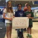 YES student, Meriem, meeting her host siblings for the first time at the airport