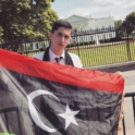 Taha holding up the Libyan flag in front of the White House