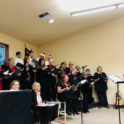 A photo of people singing in a choir