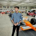 student poses at the racing track.