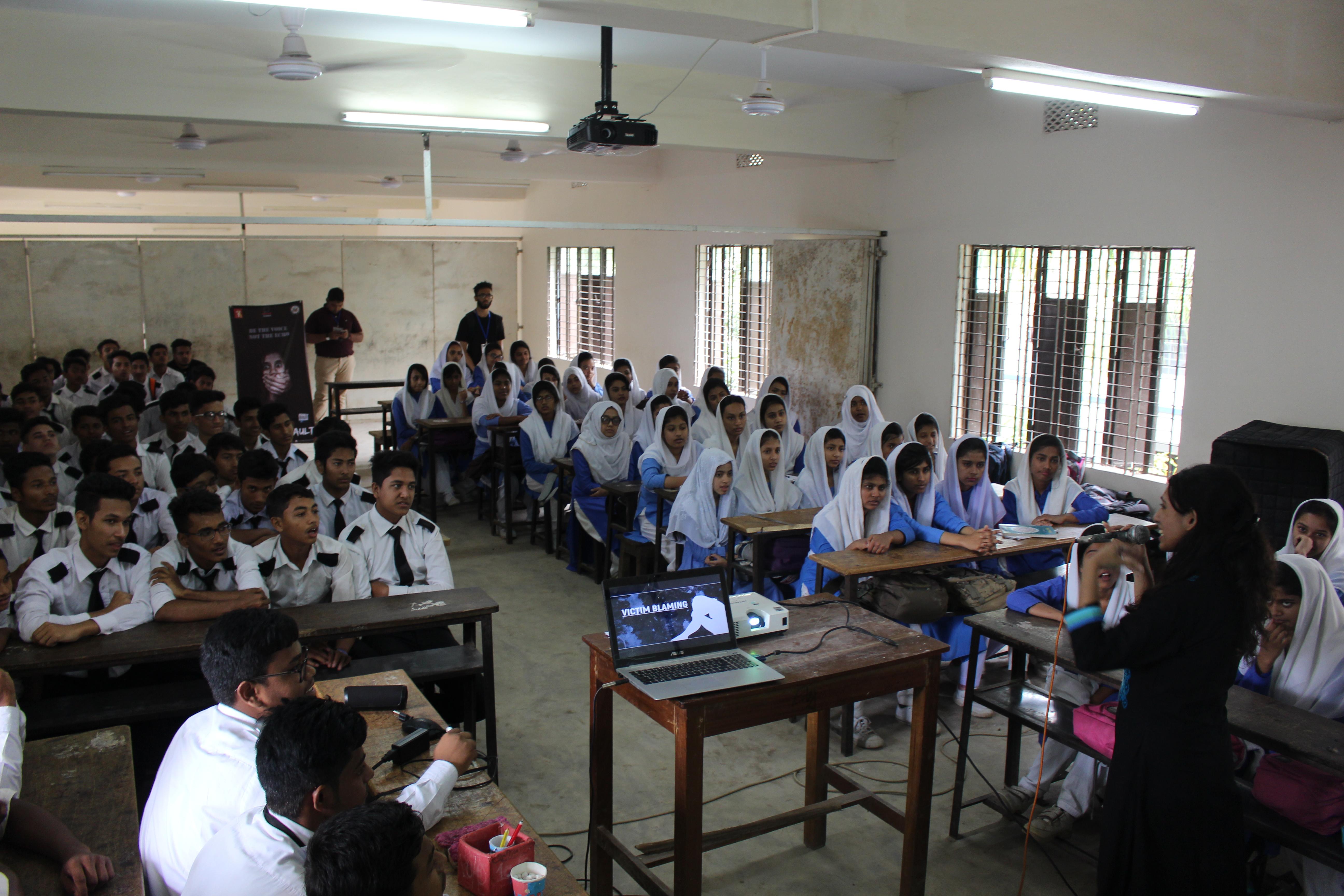 Students sitting in a classroom attending a women's empowerment workshop